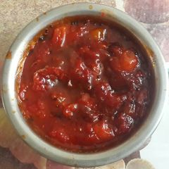 A picture of Tomato chutney with dates and aam papad (mango bars).