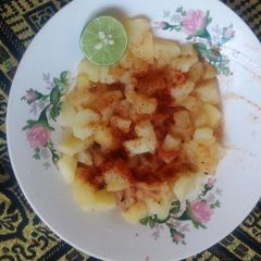 A picture of Boiled potatoes in tamarind chilli.
