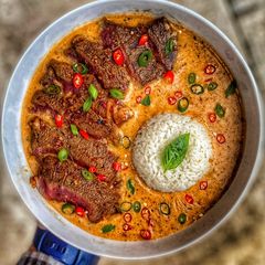 A picture of Thai Red Curry w / Ribeye Steak.