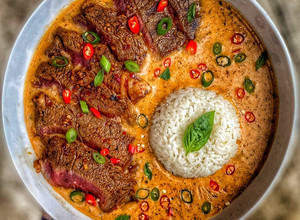 A picture of Thai Red Curry w / Ribeye Steak.