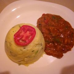 A picture of Mashed potatoes with beef stew.