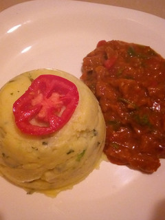 A picture of Mashed potatoes with beef stew.