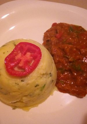 A picture of Mashed potatoes with beef stew.