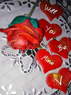 A picture of Valentines day special fondant red rose cake topper.