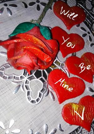 A picture of Valentines day special fondant red rose cake topper.