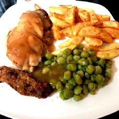 A picture of My Stuffed Peppered Chicken breast with Homemade Chips + Peas.