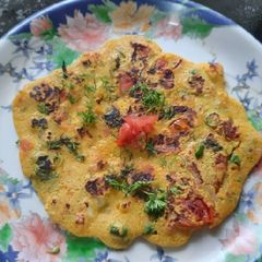 A picture of Besan onion tomato chilla.