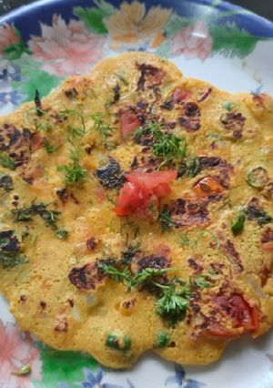 A picture of Besan onion tomato chilla.