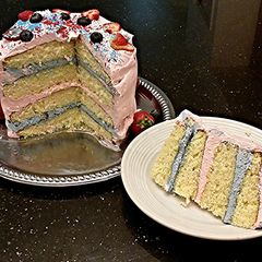 A picture of White Butter Cake with Strawberry and Blueberry Whipped Cream.