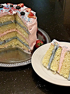 A picture of White Butter Cake with Strawberry and Blueberry Whipped Cream.