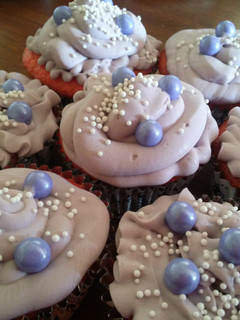 A picture of Strawberry banana cupcakes with cream cheese frosting.