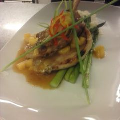 A picture of Brined pork chop with captain morgan apple demiglaze mashed potatoes and asparagus.