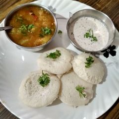 A picture of Rice idli sambhar and coconut chutney.