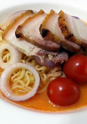 A picture of Tom Yum Instant Noodle With Roasted Pork Slice.