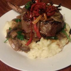 A picture of Steak with mushroom and spinach sauce..