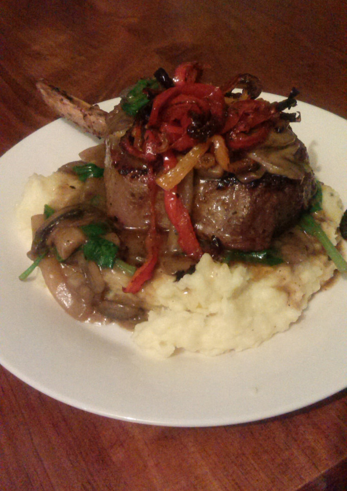 A picture of Steak with mushroom and spinach sauce..