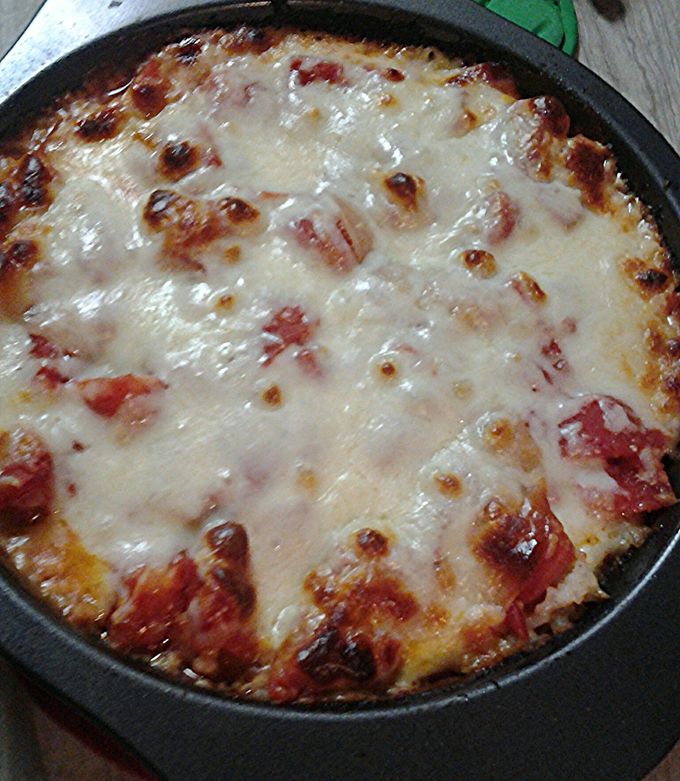 A picture of Cheesy, tomato ,and rice with a little meat pie.