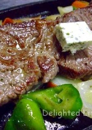 A picture of Beef Steak with Lots of Veggies.