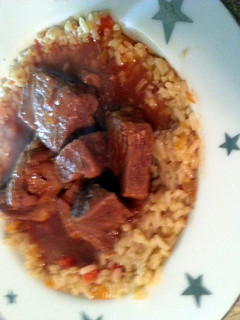 A picture of rice pilaf and tangy marinade bbq ribs.