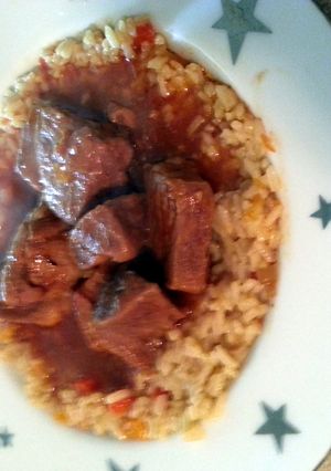 A picture of rice pilaf and tangy marinade bbq ribs.