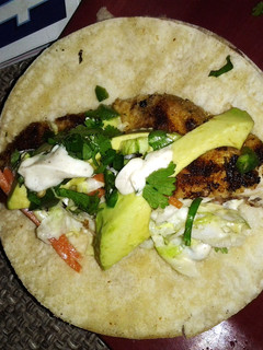 A picture of Fish taco with spicy cilantro lime sauce.