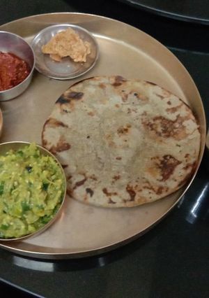 A picture of Kathiyawadi spoon Baingan Bharta with bajre rotla.