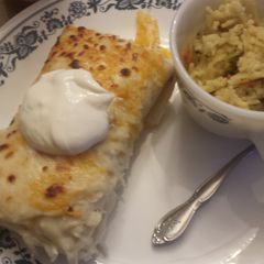 A picture of Chicken and rice enchiladas.