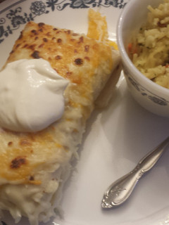 A picture of Chicken and rice enchiladas.