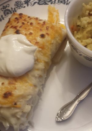 A picture of Chicken and rice enchiladas.