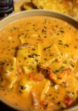 A picture of Creamy Tomato Soup with Chicken & Garlic Ravioli.