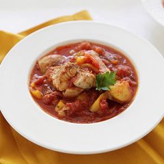 A picture of Fresh Grouper Stew with Chunks of Potatoes and Sweet Peppers.