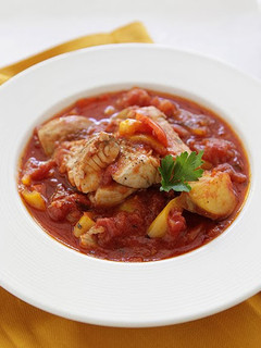 A picture of Fresh Grouper Stew with Chunks of Potatoes and Sweet Peppers.