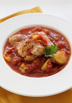 A picture of Fresh Grouper Stew with Chunks of Potatoes and Sweet Peppers.