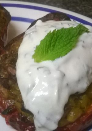 A picture of Rice stuffed peppers with mint yogurt sauce.