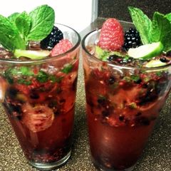 A picture of mixed berry mojitos.