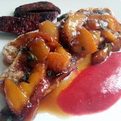 A picture of French toast and caramelized peaches with raspberry sauce.