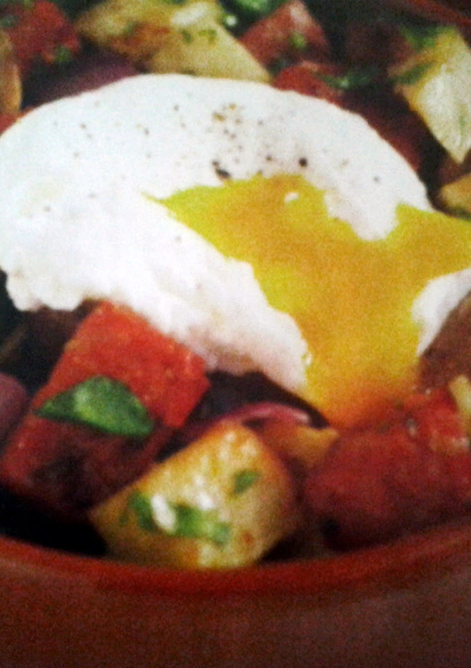 A picture of Chorizo Hash with Poached Eggs.