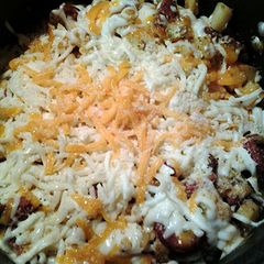 A picture of Cheesy potatoes with sausage and bacon.