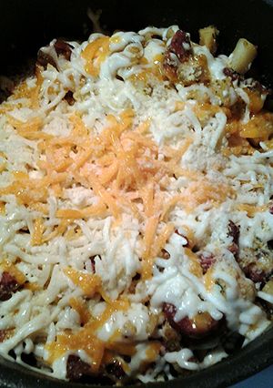 A picture of Cheesy potatoes with sausage and bacon.