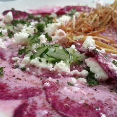 A picture of Beetroot carpaccio with goat cheese.