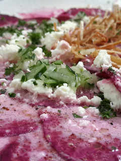 A picture of Beetroot carpaccio with goat cheese.