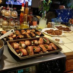 A picture of Cream cheese stuffed jalapeños with bacon.