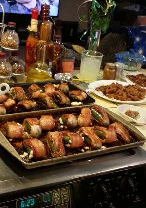 A picture of Cream cheese stuffed jalapeños with bacon.