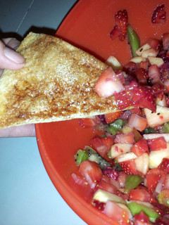 A picture of fruit salsa with baked cinnamon chips.
