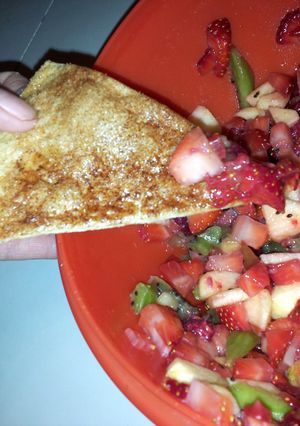 A picture of fruit salsa with baked cinnamon chips.