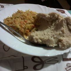 A picture of A mixture of cabbage and eggs with ugali.