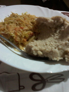 A picture of A mixture of cabbage and eggs with ugali.