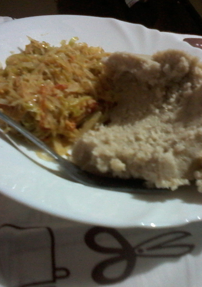 A picture of A mixture of cabbage and eggs with ugali.
