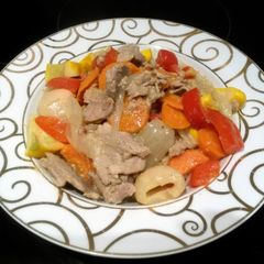 A picture of green thai curry with pork.