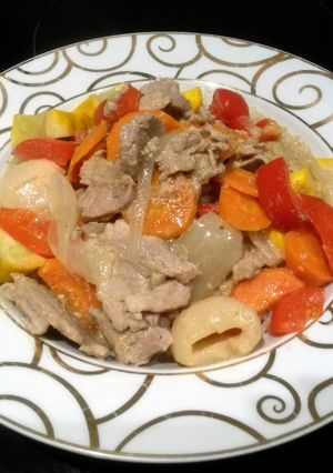 A picture of green thai curry with pork.